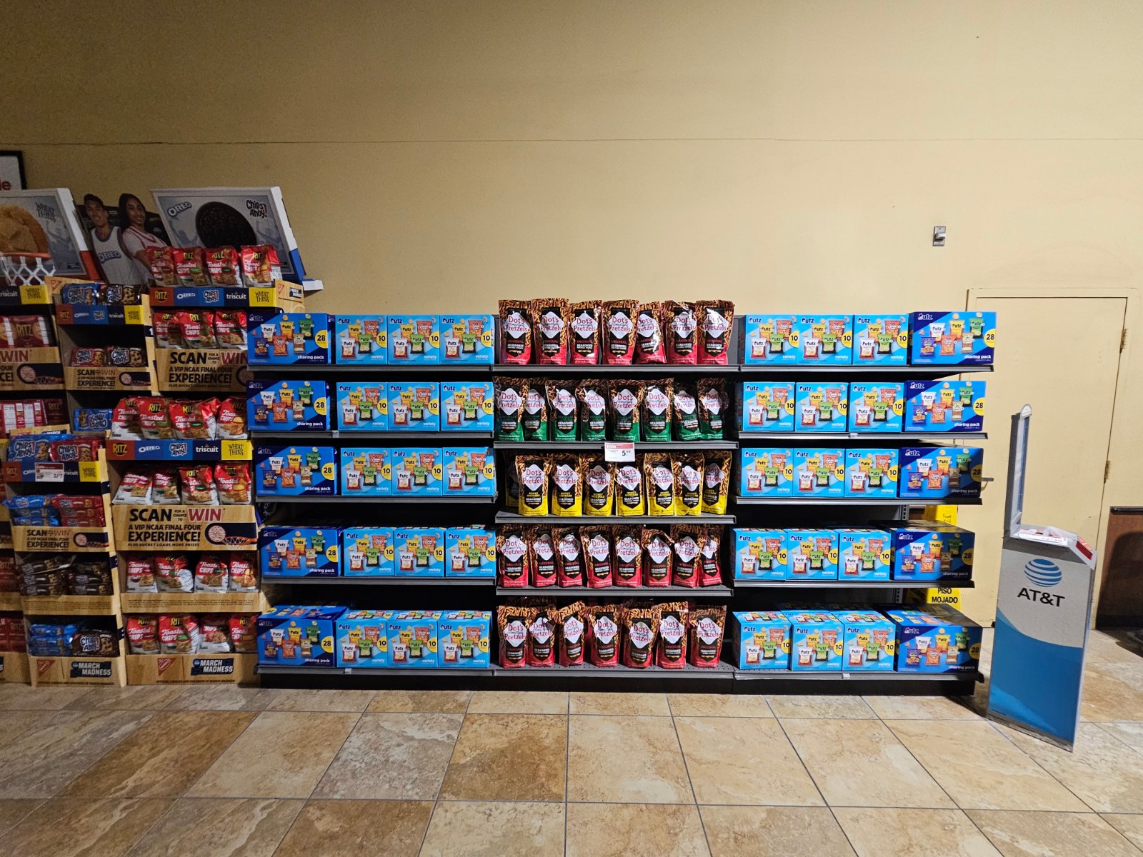 A big-box grocery aisle wall of variety sharing packs and 10-count multipacks running unbroken along a planogram, faced